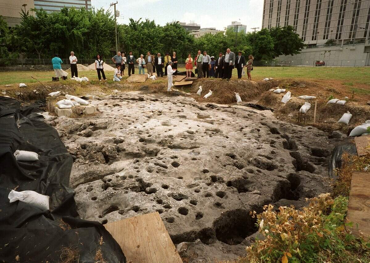 Archaeologist Ryan Wheeler, dressed in white at center, speaks in 2001 to members of a state task force planning the future of the site of the 2,000-year-old Miami Circle, discovered in 1998 at the mouth of the Miami River.