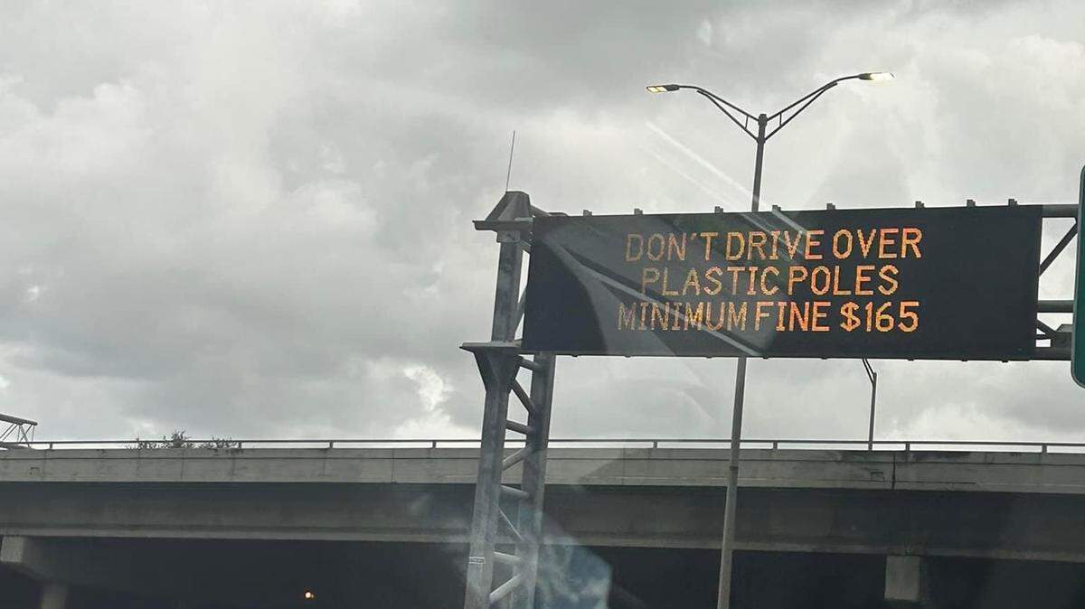 An elctronic sign on a stretch of I-95 in Broward warns drivers not to run over the poles.
