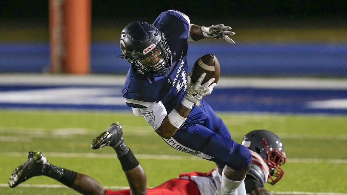 Columbus High running back Henry Parrish Jr. (4) breaks a tackle for extra yards in the first quarter as Columbus faces Coral Gables at Tropical Park in a high school football playoff game on Friday, November 9, 2018.