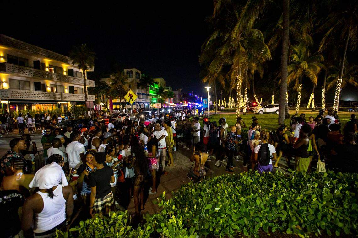 Crowds fill the sidewalk along Ocean Drive during spring break in Miami Beach, Florida, on Saturday, March 19, 2022.