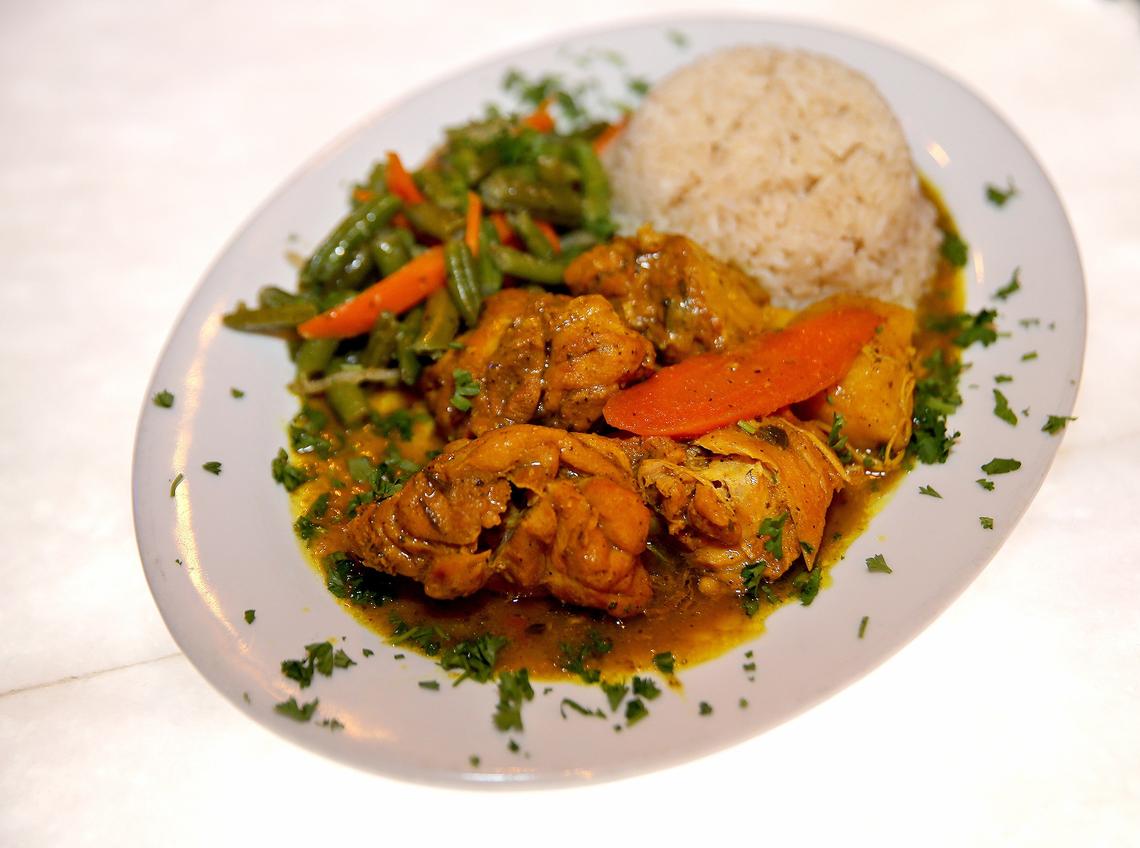 Chicken curry with green beans and white rice from Lorna’s Caribbean and American Grille