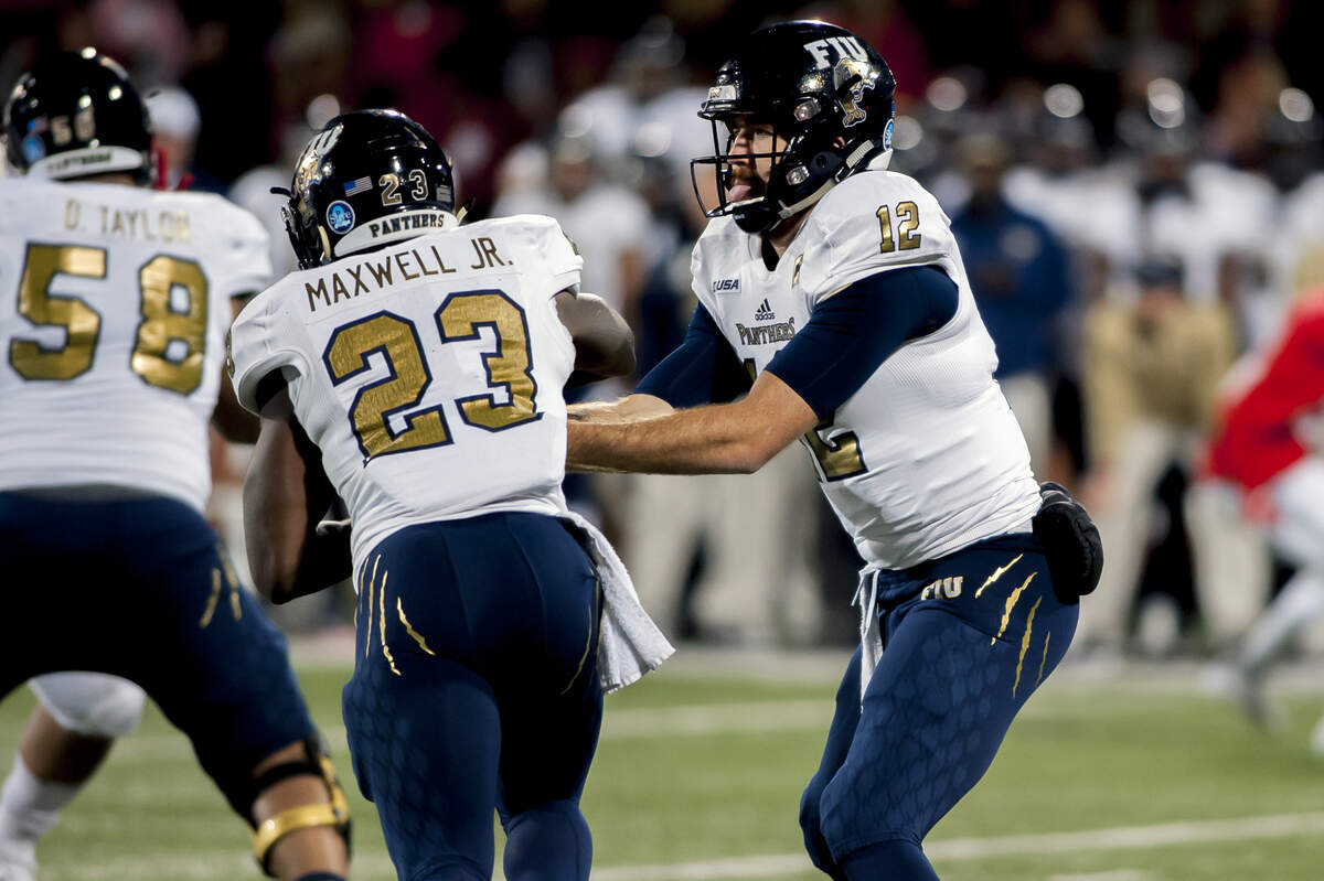 FIU quarterback James Morgan hands off to running back Napoleon Maxwell (23) Saturday, October 27, 2018, during a game at Houchens-Smith Stadium.