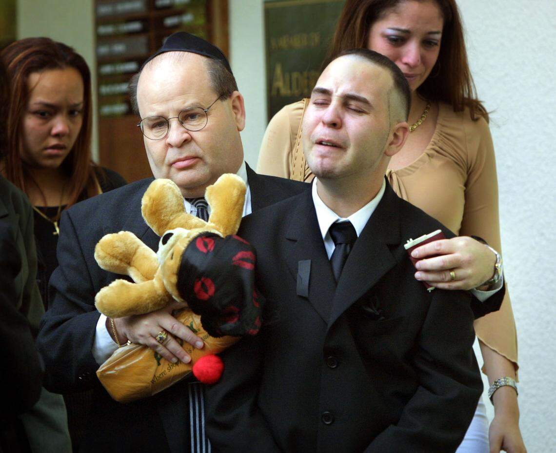 Gary and Joshua Karp, Marissas’ father and brother, exit the funeral services for Marissa Karp on Oct. 3, 2002.