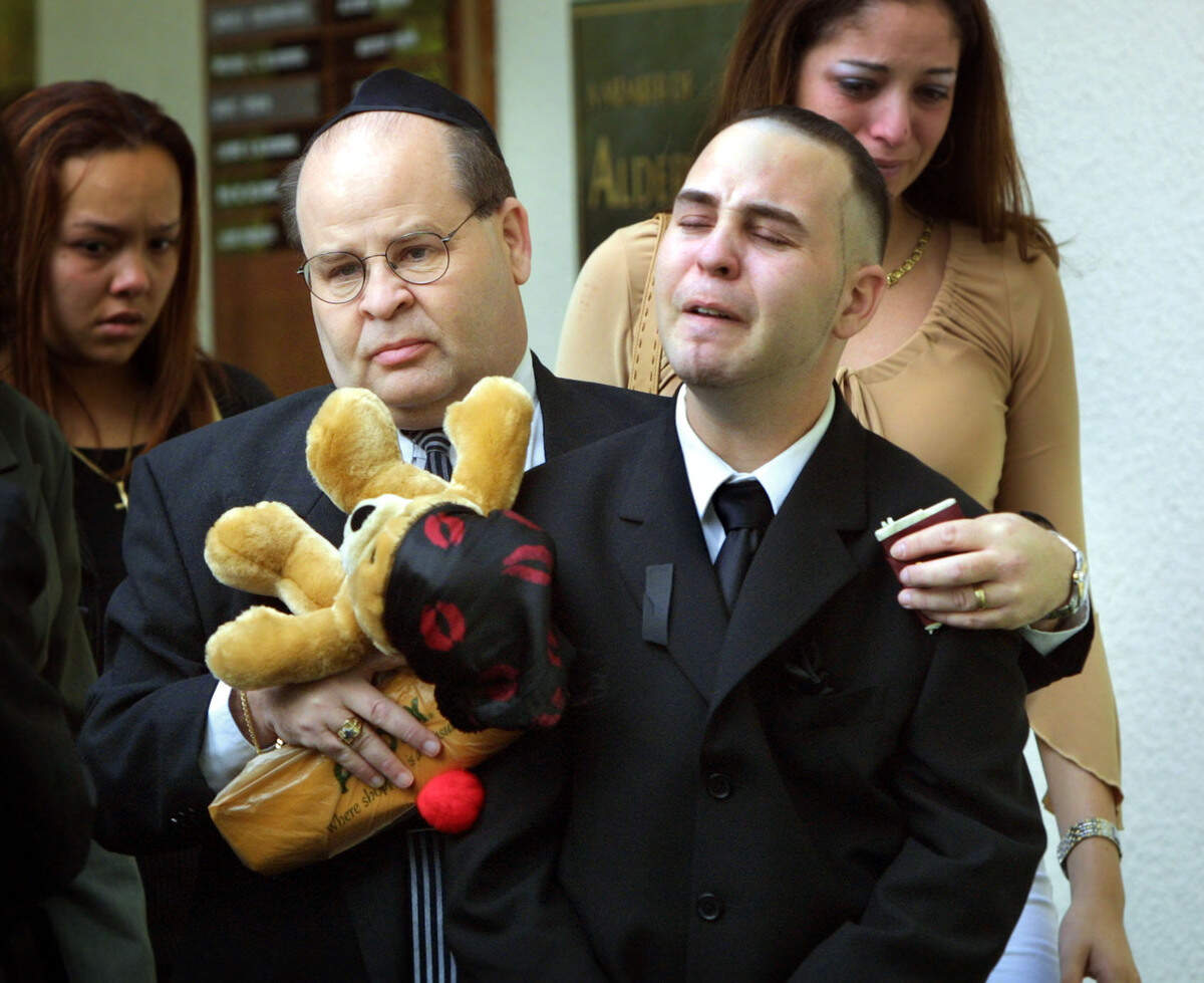 Gary and Joshua Karp, Marissas’ father and brother, exit the funeral services for Marissa Karp on Oct. 3, 2002.