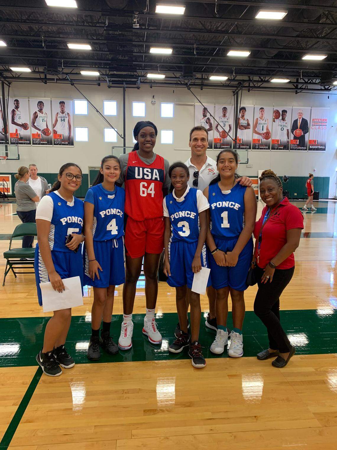 One of the members of the USA women’s basketball team, center, who was practicing with the team at the University of Miami, meets with girls on the basketball team at Ponce de Leon Middle School in Coral Gables. At right is Toni Junious, an adviser for The Home Team.