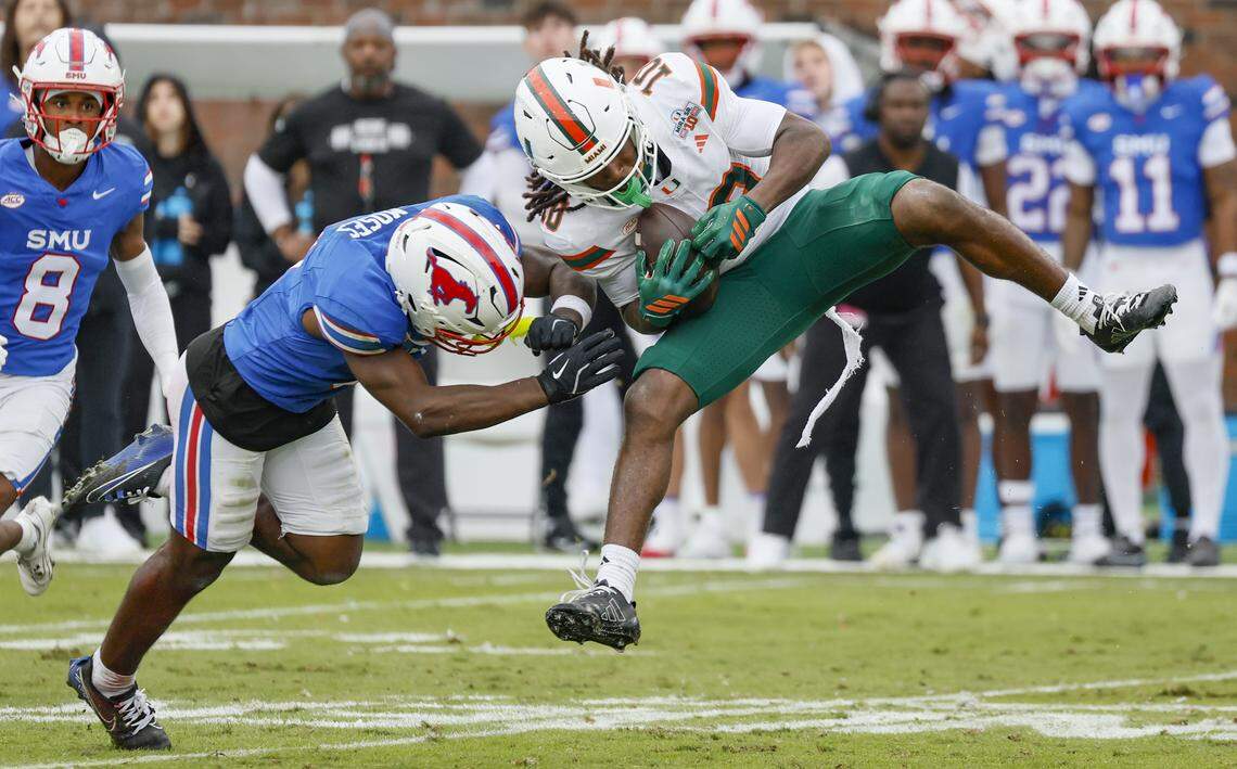 Miami Hurricanes wide receiver Malachi Toney (10) is hit on a pass reception by Southern Methodist University Mustangs safety Ahmaad Moses (3) during the first half of an NCAA football game at Gerald Ford Stadium on Saturday, November 1, 2025, in Dallas, Texas.