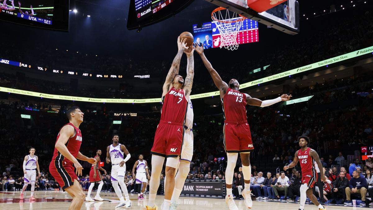 Miami Heat centers Kel'el Ware (7) and Bam Adebayo (13) defend the basket during the first half of a game against the Utah Jazz on Feb. 9, 2026, at the Kaseya Center in Miami.