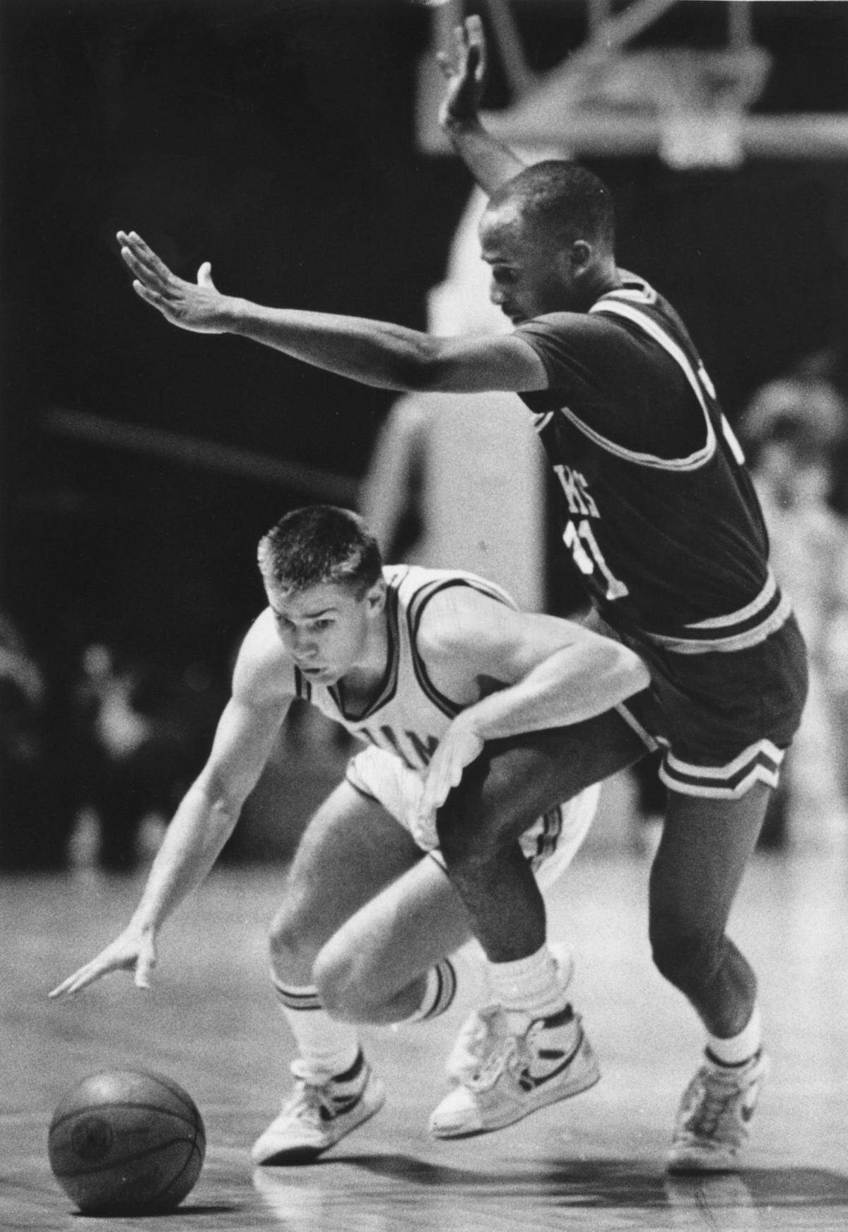 UM basketball player Kevin Presto advances the ball down court.