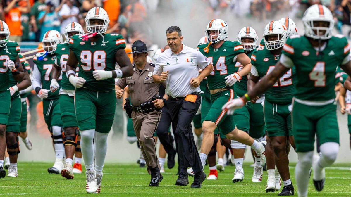Miami Hurricanes Head Coach Mario Cristobal runs out with his team before the first half of an ACC conference football game against the Duke Blue Devils at Hard Rock Stadium on Saturday, Nov. 2, 2024, in Miami Gardens, Fla.