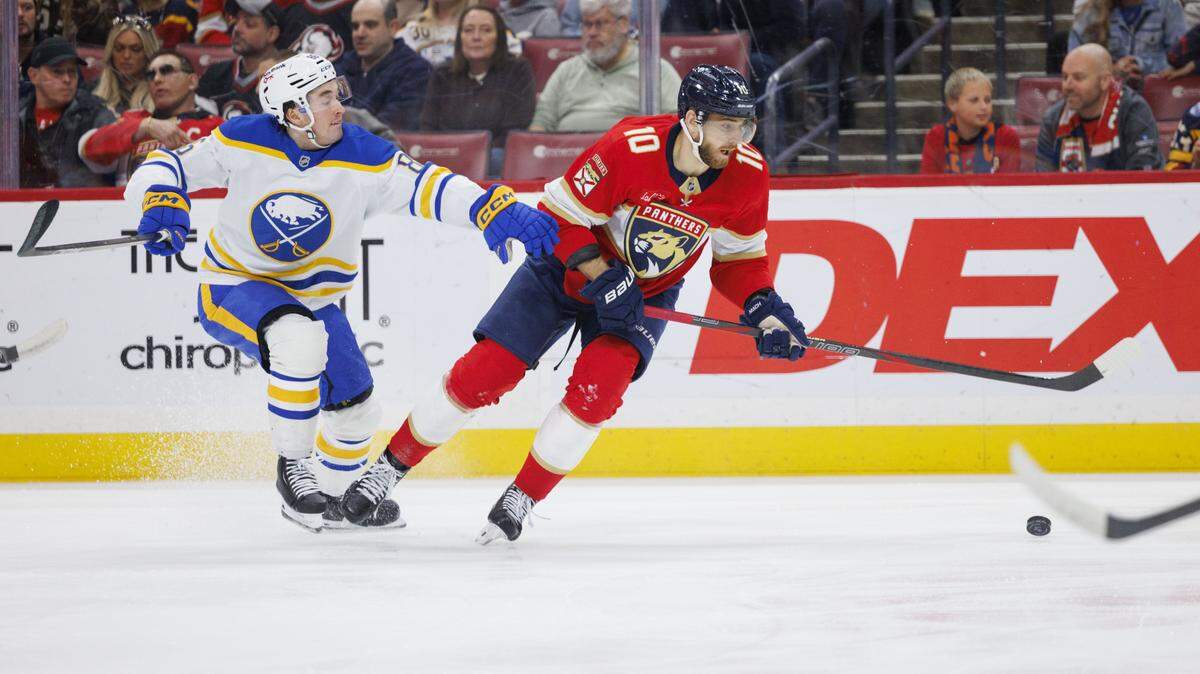 Florida Panthers left wing A.J. Greer (10) takes the puck around Buffalo Sabres center Noah Ostlund (86) during the first period of a game on Monday, Feb. 2, 2026, at Amerant Bank Arena in Sunrise, Fla.