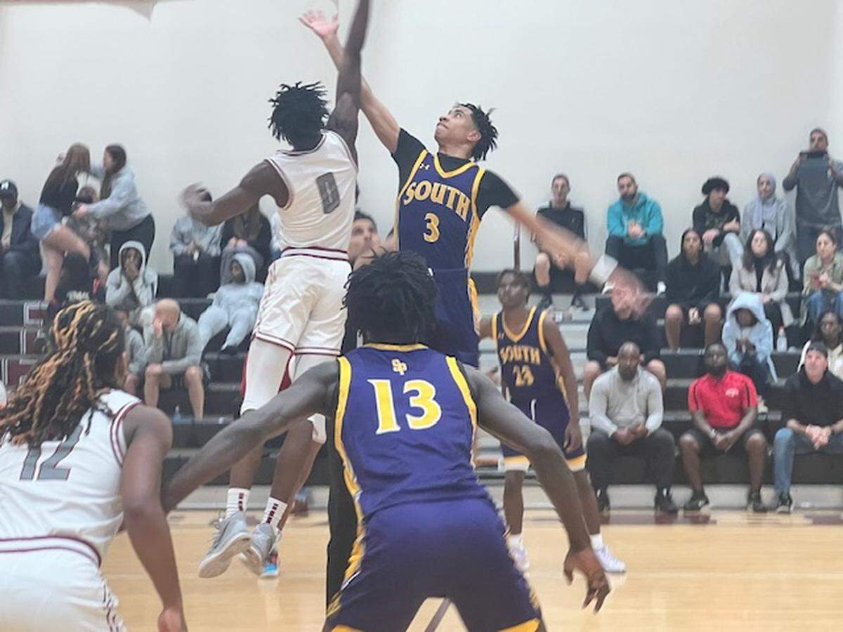 Opening tip-off between Jeremy Elyzee (No. 0) of Pines Charter and Lathan Coleman (No. 3) of South Plantation to start Tuesday night’s Region 4-6A semifinal at Pines Charter.