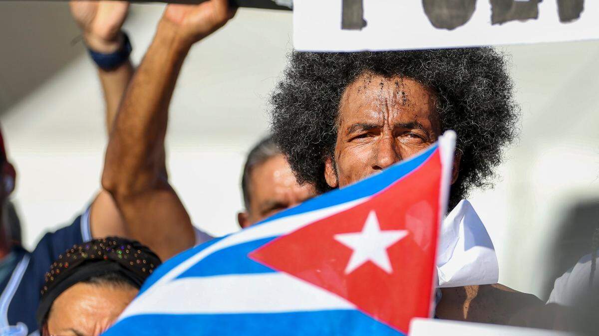 In 2022, Cuban artist Luis Eligio stands outside Versailles restaurant in Miami’s Little Havana at a rally to commemorate the first anniversary of the July 11 mass protests in Cuba.