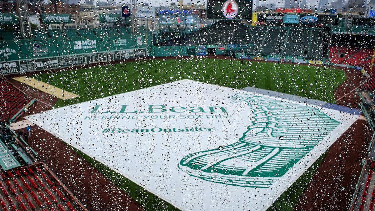A tarp lies on the Fenway Park infield on Sunday, May, 30, 2021 in Boston.