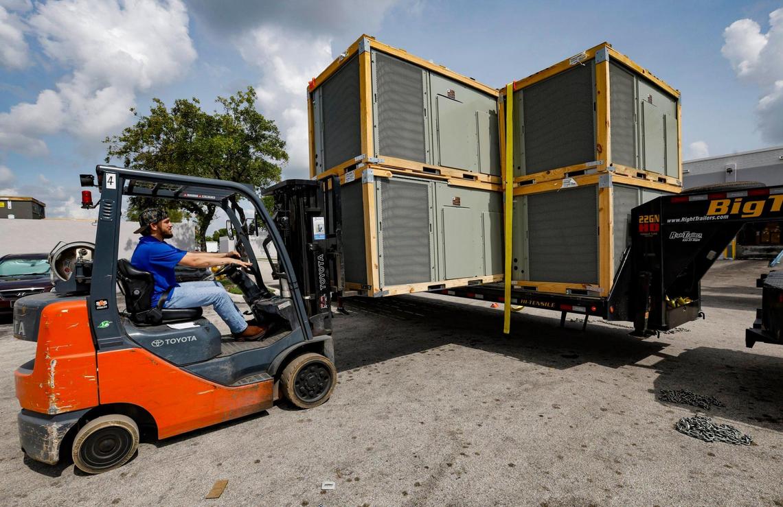 Chris Mejia uses a forklift to move commercial air conditioning units into the Watsco Gemaire warehouse in Doral, on June 30, 2023.
