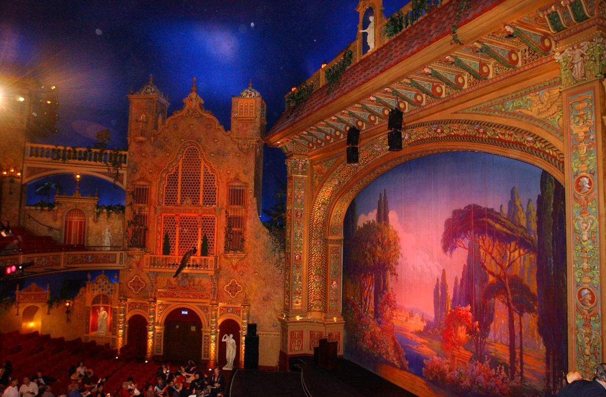 The elaborate auditorium at downtown Miami’s historic Olympia Theater, seen here after a 2002 renovation, is designed to recall a Spanish garden. The ceiling replicates a night sky complete with passing clouds and twinkling stars.