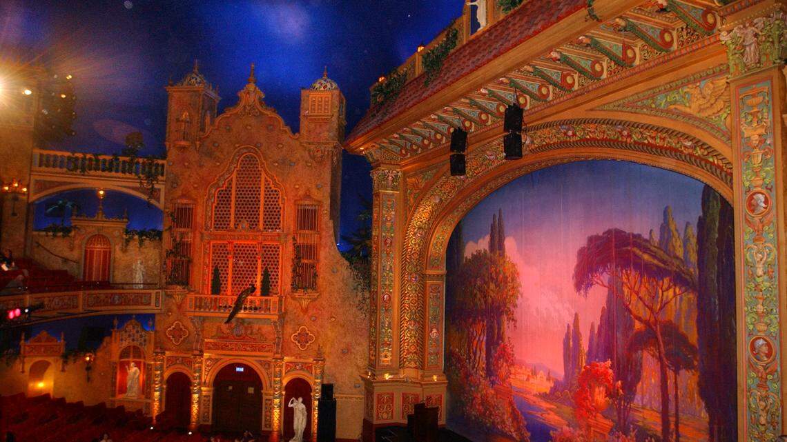 The elaborate auditorium at downtown Miami’s historic Olympia Theater, seen here after a 2002 renovation, is designed to recall a Spanish garden. The ceiling replicates a night sky complete with passing clouds and twinkling stars.