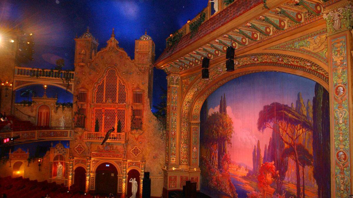 The elaborate auditorium at downtown Miami’s historic Olympia Theater, seen here after a 2002 renovation, is designed to recall a Spanish garden. The ceiling replicates a night sky complete with passing clouds and twinkling stars.