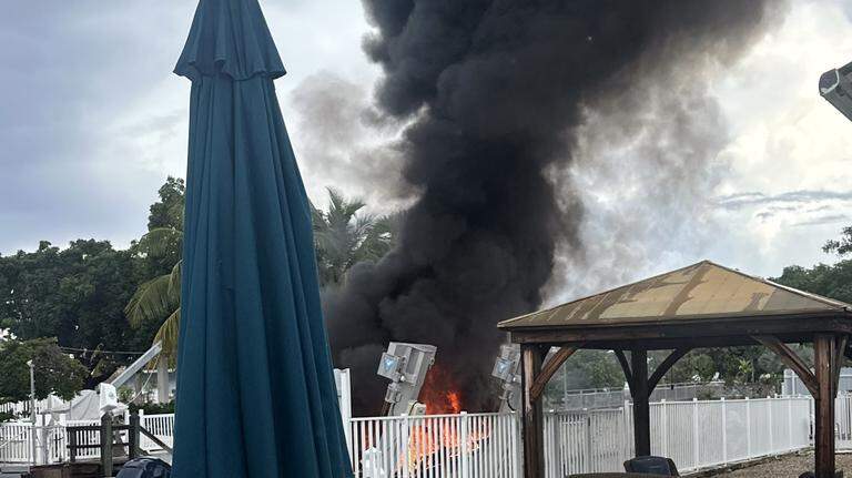 Boat goes up in flames behind Florida Keys house