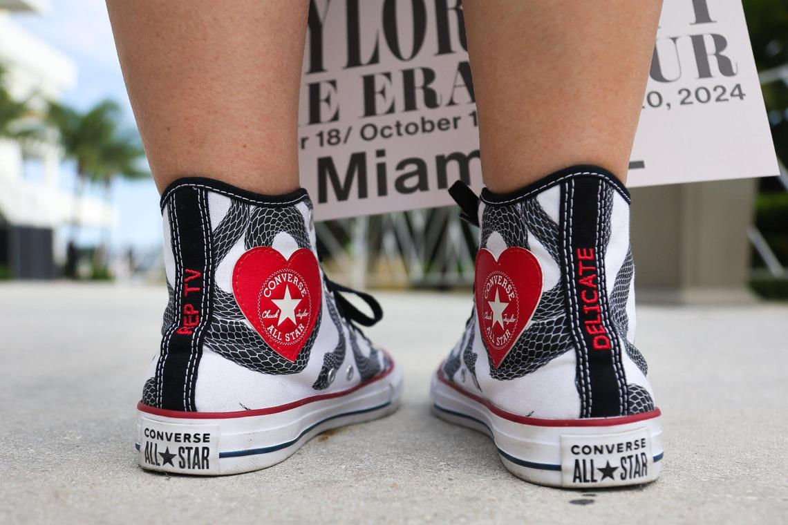 Janier Sideregts, 47, shows her custom-made Taylor Swift Converse shoes after visiting the Taylor Swift Eras Tour merchandise store at Hard Rock Stadium in Miami Gardens, Florida, Wednesday, October 16, 2024.
