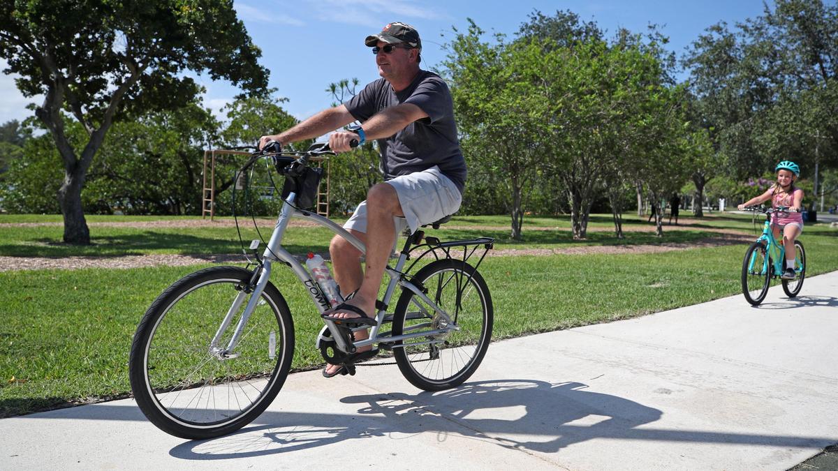 Rich Barnhart and his daughter Reese ride their bicycles at George English Park in Fort Lauderdale after the park was reopened on Wednesday, April 29, 2020. ...SOUTH FLORIDA OUT; NO MAGS; NO SALES; NO INTERNET; NO TV...