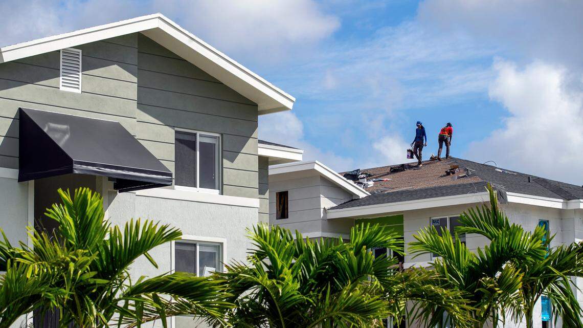 Two workers atop a roof of one of the apartment buildings completed during the second phase of Liberty Square, the redevelopment project by Related Urban, the Related Group’s affordable housing division. The company opened the second phase of the project, adding another 204 units, on Oct. 31, 2020.