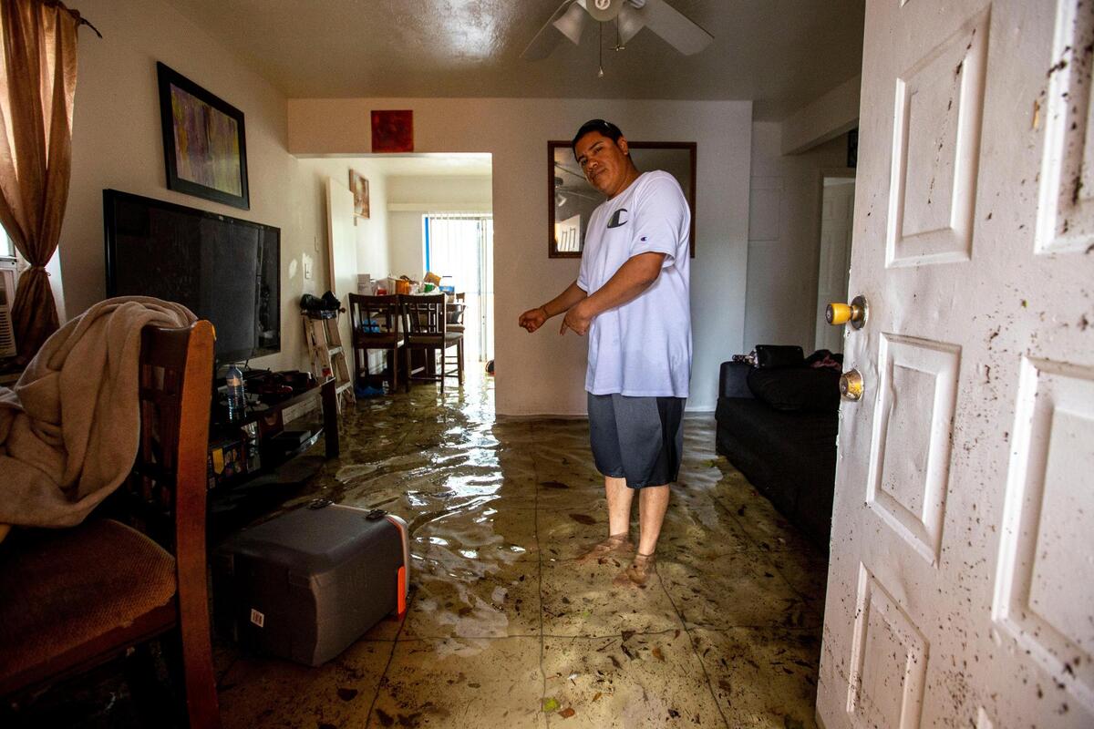 Olban Tremeneo Lagos, 42, points to the water inside his apartment off Southwest Third Street and Eighth Avenue in the Little Havana neighborhood of Miami, Florida, on Saturday, June 4, 2022.
