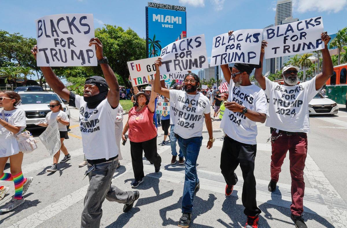 Blacks for Trump counter protesters walk through a No Kings protest June 14 at Bayfront Park in Miami.