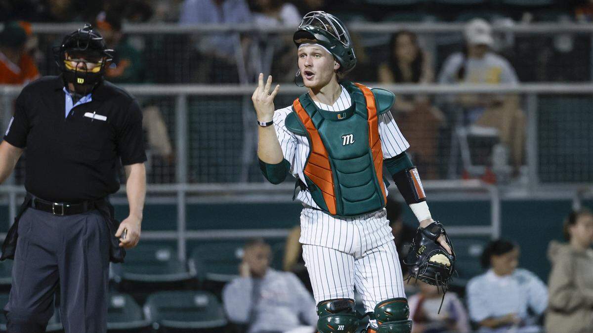 Miami Hurricanes catcher Alex Sosa (13) signals towards the dug out during the Hurricanes season opener against the Lehigh Mountain Hawks at Mark Light Field in Coral Gables, Florida, Florida on Friday, February 13, 2026