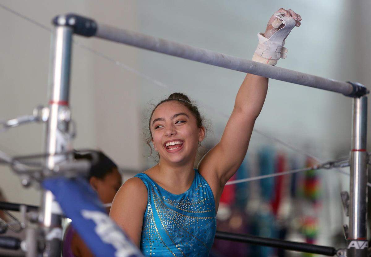 Bianca Leon, who in July won a gold medal representing Puerto Rico in the Central American and Caribbean Games, practices on the uneven bars at Leyva Gymnastics in Kendall on Wednesday, Aug. 15, 2018.