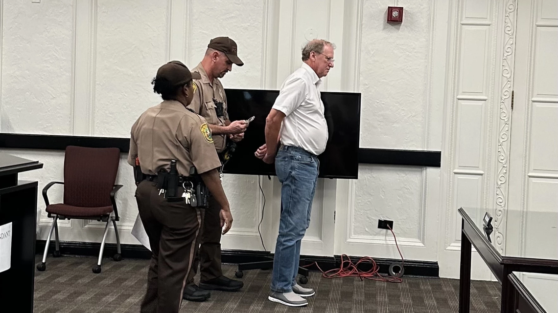 Everglades scientist Tom Van Lent, 67, is handcuffed in a Miami-Dade County courtroom after surrendering Thursday, July 17, to serve a 10-day jail sentence for contempt of court.