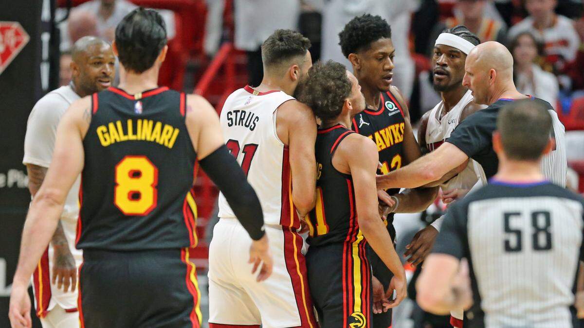 Miami Heat forward Jimmy Butler (22) and Atlant Hawks guard Trae Young (11) scuffle on the court after Butler gets fouled and the offical pushes them apart in the first quarter at the FTX Arena in Miami, Florida on Sunday, April 17, 2022.