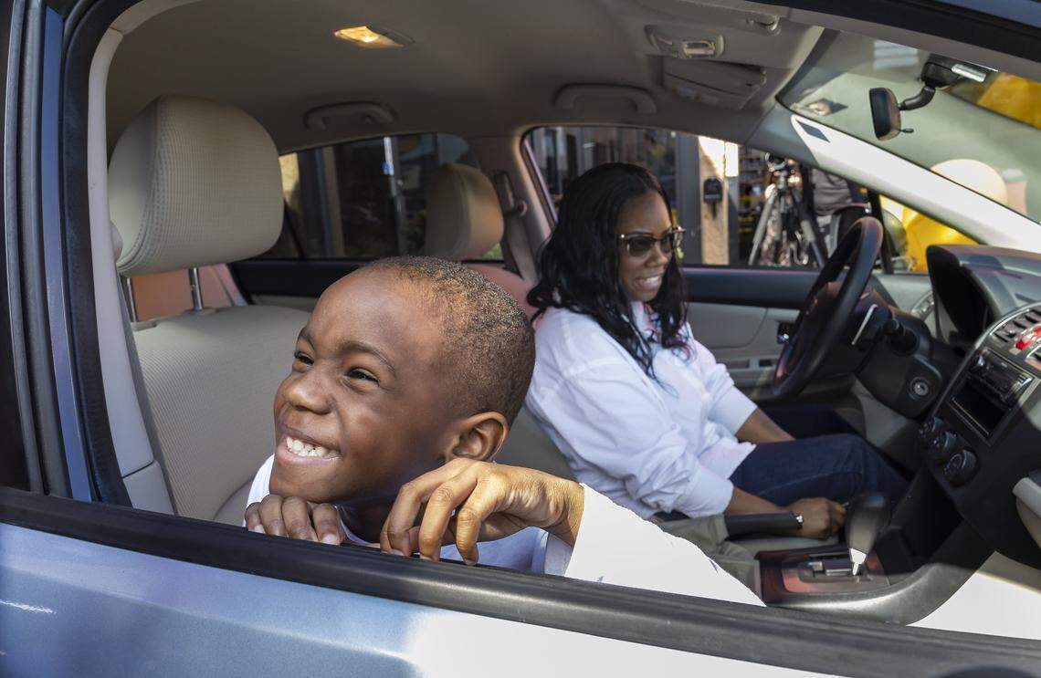 Kingston Allen, 4, and his mom, Renee King, 36, react as they inspect the refurbished Subaru Impreza they were gifted at a Midas on Thursday, Feb. 12, 2026, in Fort Lauderdale, Fla. King, a single mom with two children, was forced to give up her previous car and relied entirely on public transportation to get to work.