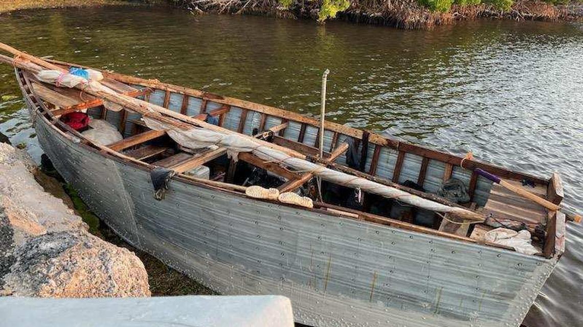 A Cuban migrant boat floats next to a Florida Keys seawall Saturday, Dec. 31, 2022. The U.S. Border Patrol said 88 people from Cuba arrived in the Keys since the day before. On New Year’s Day, several other migrant groups arrived in the island chain.