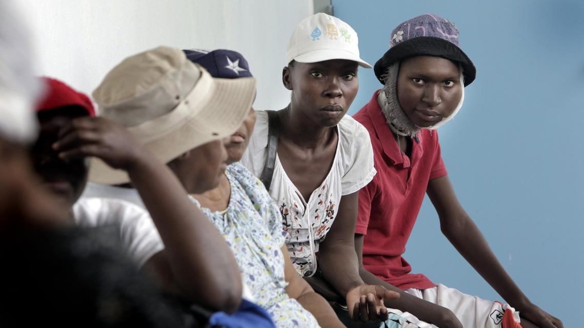 Djooly Jeune, 17, and his mother, Angena Altidor, wait with cancer patients at the University Hospital of Mirebalais. Djooly, who has Burkitt’s lymphoma, was unable to get his chemotherapy that day.