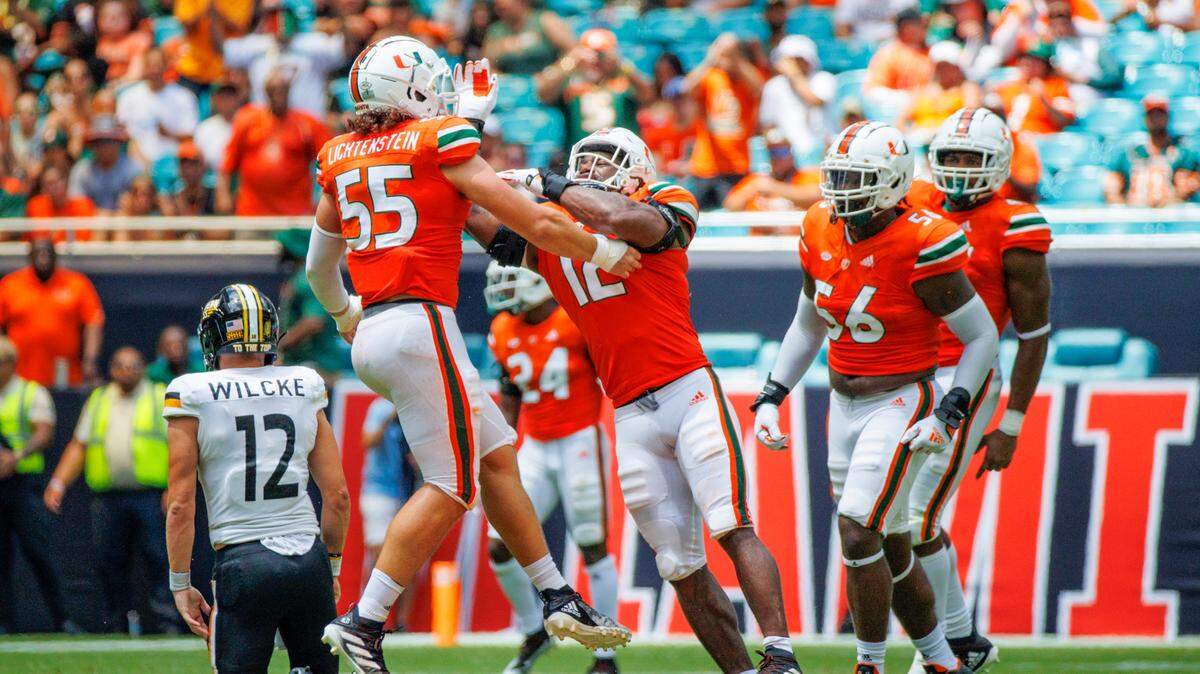 Miami Hurricanes defensive lineman Jacob Lichtenstein (55) celebrates with teammates after sacking Southern Miss Golden Eagles quarterback Zach Wilcke (12) during the second quarter of an NCAA non conference game at Hard Rock Stadium on Saturday, September 10, 2022 in Miami Gardens, Florida.