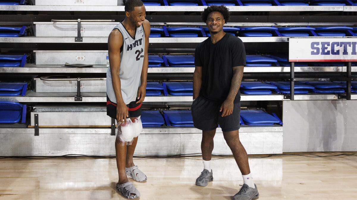 Andrew Wiggins (22) laughs with Davion Mitchell (45) during the first day of Miami HEAT Training Camp on Tuesday, Sept. 30, 2025, at Florida Atlantic University in Boca Raton, Fla. 