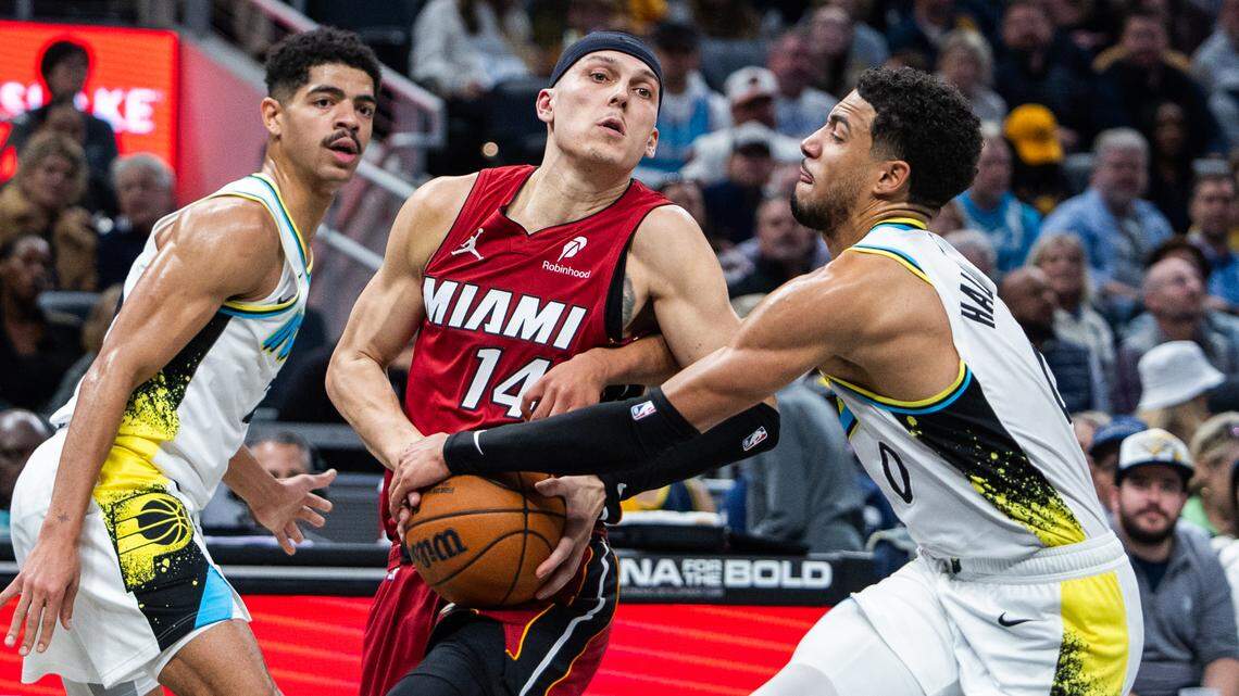 Miami Heat guard Tyler Herro (14) attempts to shoot the ball while Indiana Pacers guard Tyrese Haliburton (0) defends in the second half at Gainbridge Fieldhouse.