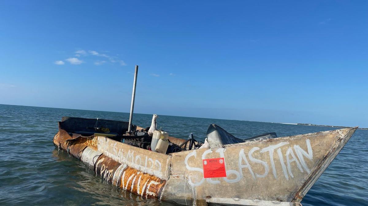 A makeshift migrant boat floats just offshore Long Key in the Florida Keys Friday morning, Feb. 3, 2023. According to the U.S. Border Patrol, 29 people from Cuba were on the vessel.