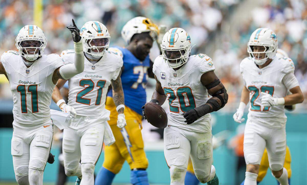 Miami Dolphins linebacker Jordyn Brooks (20) celebrates with his teammates after recovering a fumble against the Los Angeles Chargers in the first half of their NFL game at Hard Rock Stadium on Sunday, Oct. 12, 2025, in Miami Gardens, Fla.
