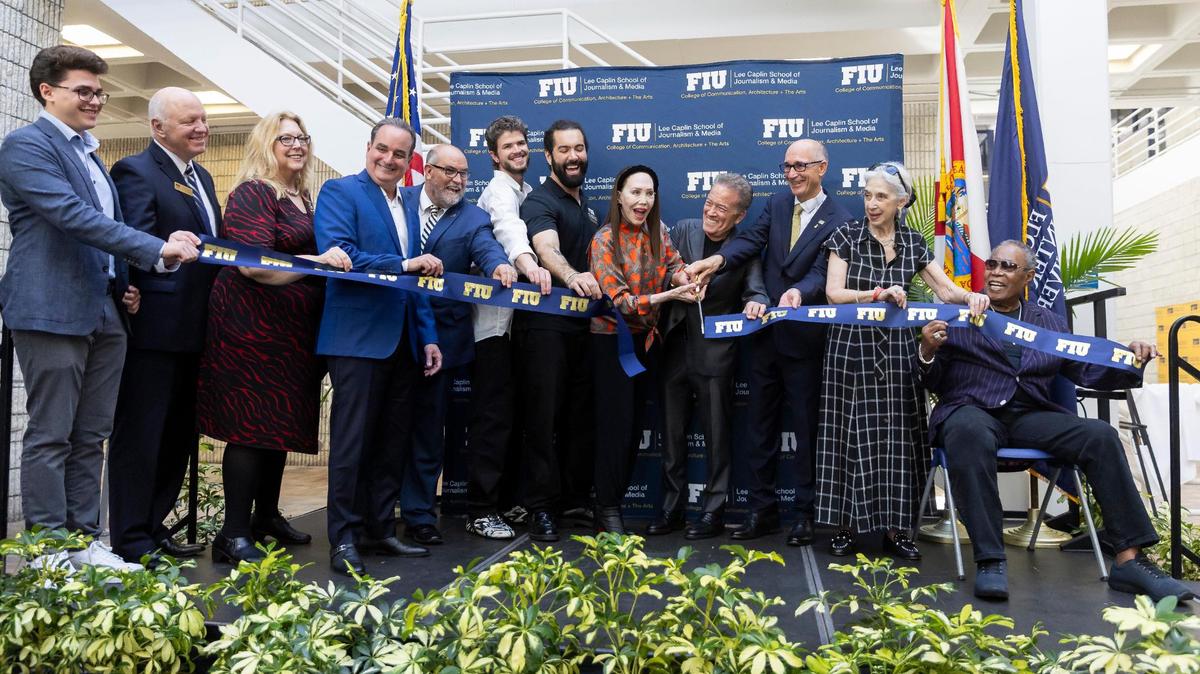 American singer Sam Moore, far-right, and Lee Caplin, at center, participate in a ribbon-cutting ceremony at the Florida International University Biscayne Bay Campus on Friday, Nov. 17, 2023, in North Miami, Fla. The ceremony was held to officially unveil the Lee Caplin School of Journalism & Media, the iSTAR Volumetric Capture Studio and the Sam Moore: The Legendary Soul Man Theatre.