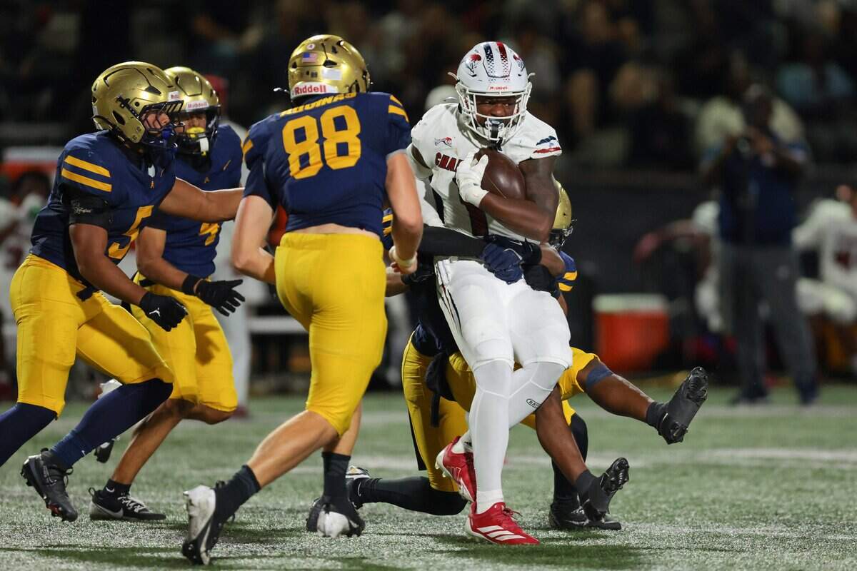 Chaminade-Madonna Lions running back Derek Cooper (1) carries the football against the St. Thomas Aquinas Raiders during the second quarter of a high school football game at St. Thomas Aquinas in Fort Lauderdale, Florida, Friday, October 31, 2025.