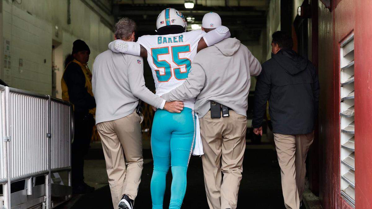 Miami Dolphins linebacker Jerome Baker (55) is assisted to the locker room after injury in the first half during the game against the Washington Commanders at FedEx Field in Landover, Maryland on Sunday, December 3, 2023. 