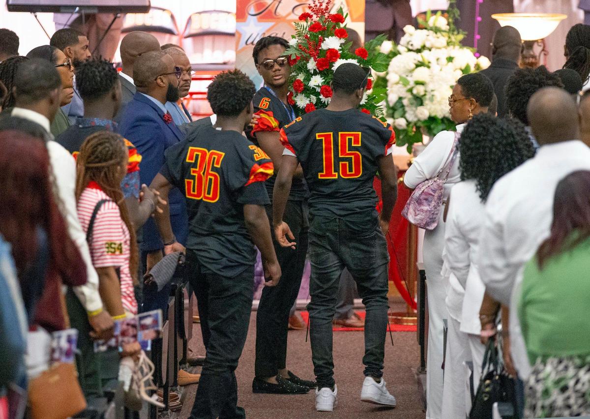 Teammates carry flowers during a memorial service for Bryce Jaden-Lee Zane Gowdy, a senior football player at Deerfield Beach High School on Saturday, January 11, 2020.