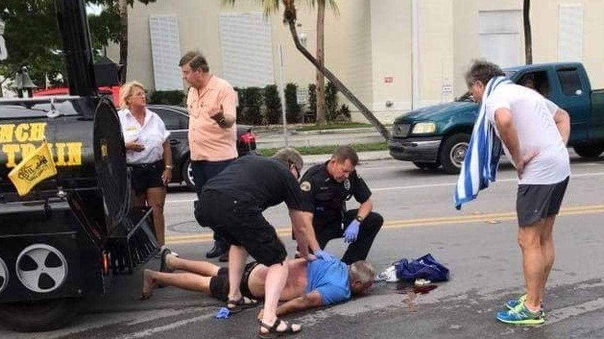 Police and passersby help a homeless man struck by a Conch Train tourist vehicle on May 17, 2018.