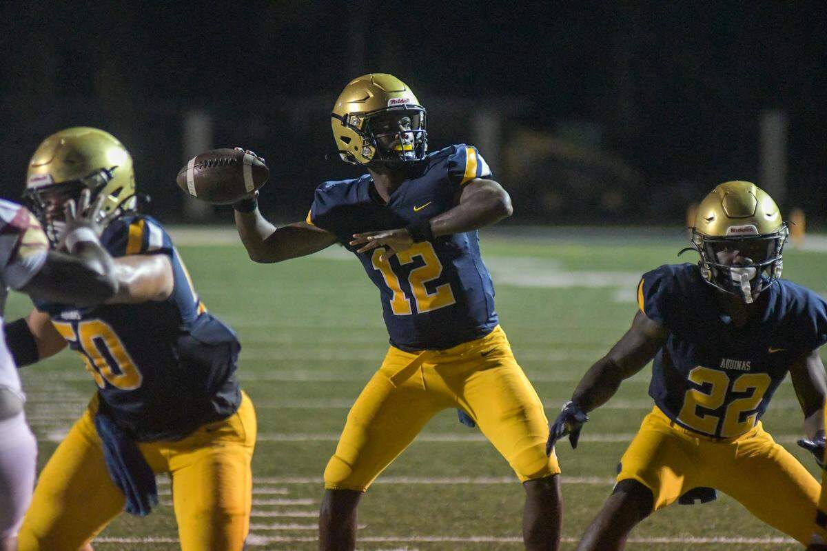 St. Thomas Aquinas quarterback Hezekiah Harris drops back to pass in a Region 3-3M quarterfinal game against Coconut Creek on Friday, Nov. 11, 2022, at St. Thomas Aquinas High School in Fort Lauderdale, Florida.