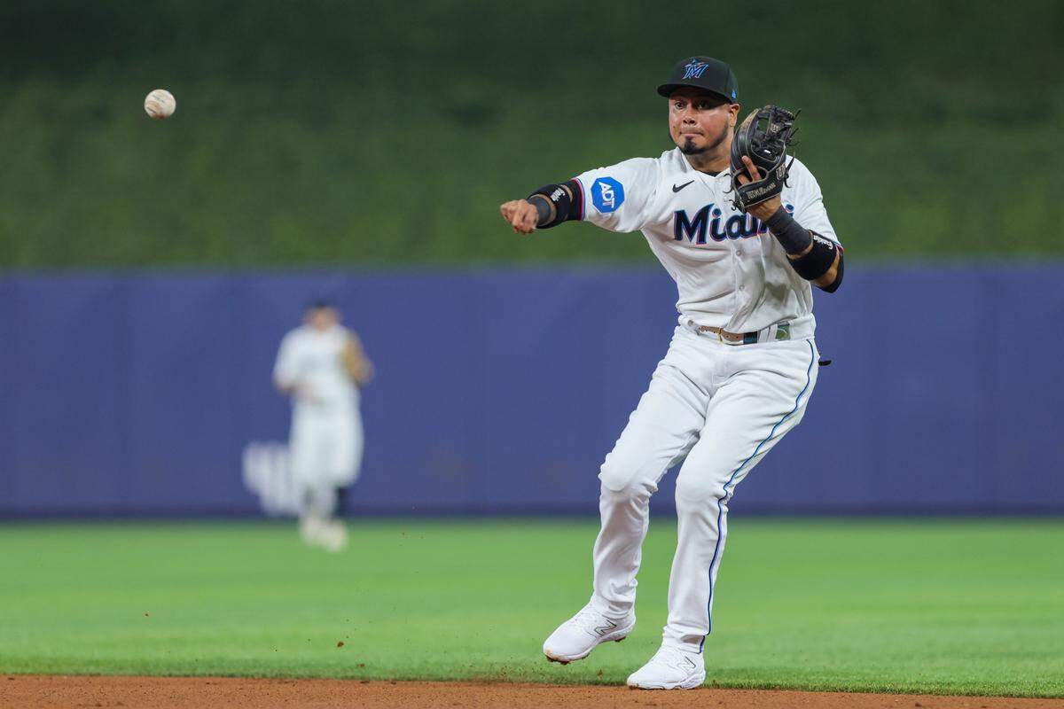 Jul 30, 2023; Miami, Florida, USA; Miami Marlins second baseman Luis Arraez (3) throws to first baseman Yuli Gurriel (not pictured) but cannot retire Detroit Tigers shortstop Javier Baez (not picuted) during the second inning at loanDepot Park.