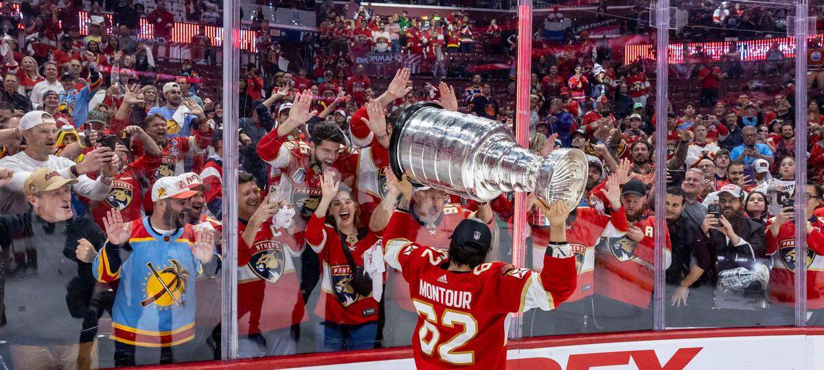 Sunrise, Florida, June 24, 2024 - Florida Panthers defenseman Brandon Montour (62) shows the Stanley Cup to Panthers fans during the celebration following their victory over the Edmonton Oilers.