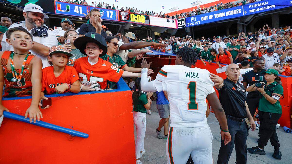 Miami Hurricanes quarterback Cam Ward (1) celebrates with fans after the Canes defeat the Florida Gators in an NCAA college football game at Ben Hill Griffin Stadium in Gainesville, Florida, on Saturday, August 31, 2024.