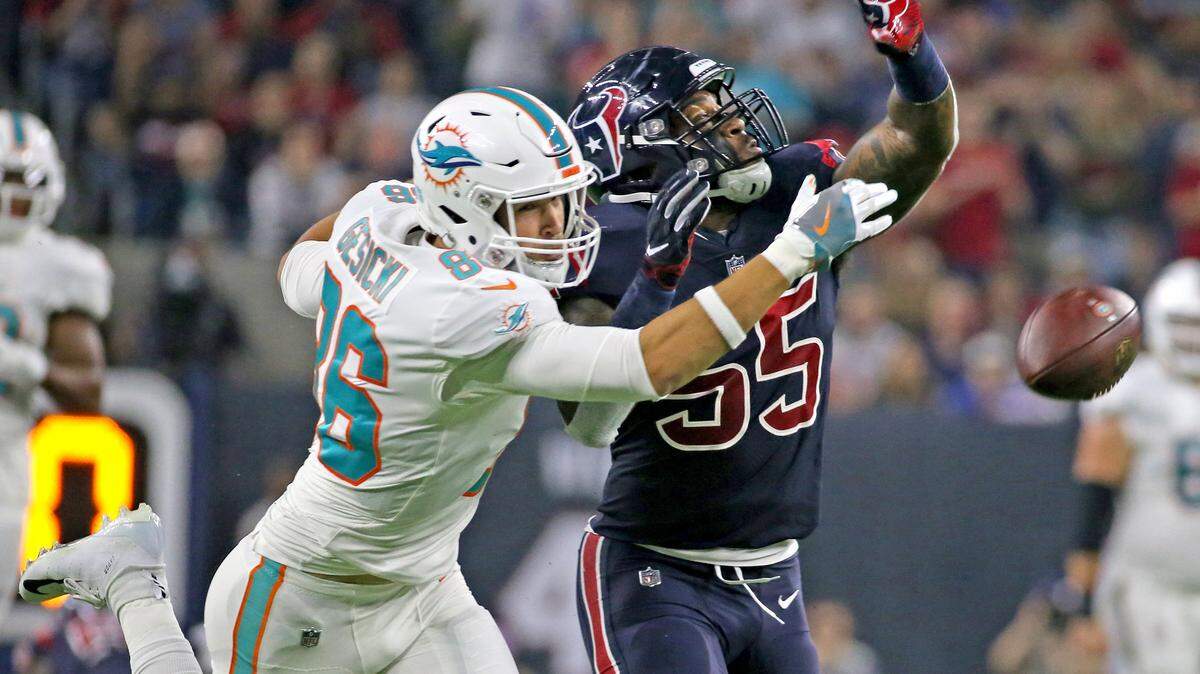 Miami Dolphins tight end Mike Gesicki can’t reach the ball as the Houston Texans’ Benardrick McKinney defends him in the Oct. 25 game.