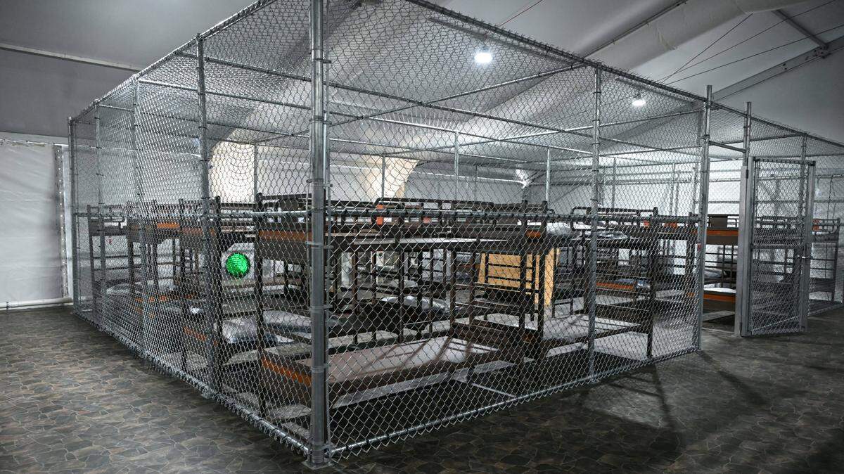 Bunk beds surrounded by chain link fencing await detainees inside a migrant detention center, Alligator Alcatraz, in the Everglades that opened on Tuesday.